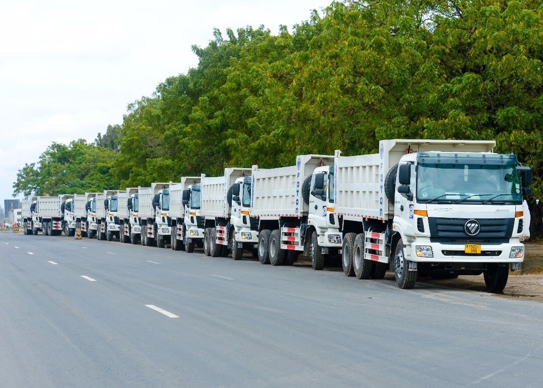NAM freight trucks lined along a Tanzanian road